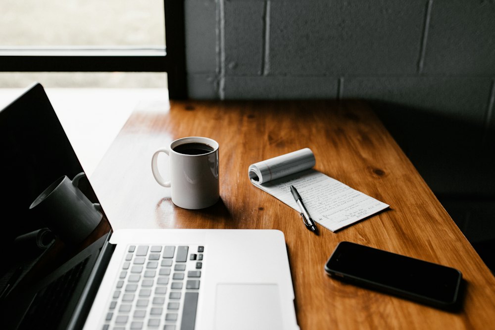 Desk with a laptop and coffee
