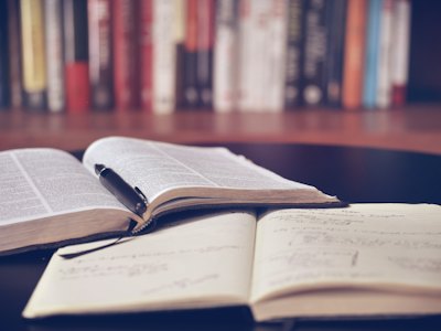 Open book and a cup of coffee on a table