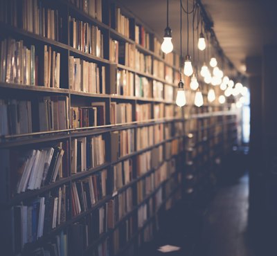Row of books on a shelf seen from the side