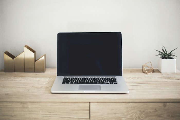 A thin laptop on a wooden table
