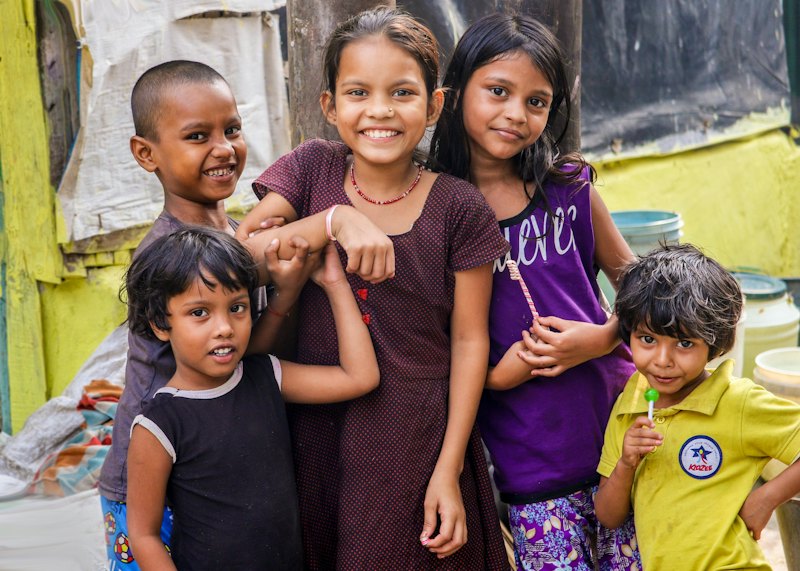 Group of smiling children standing together outside