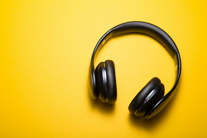 Over-ear headphones on a colored background
