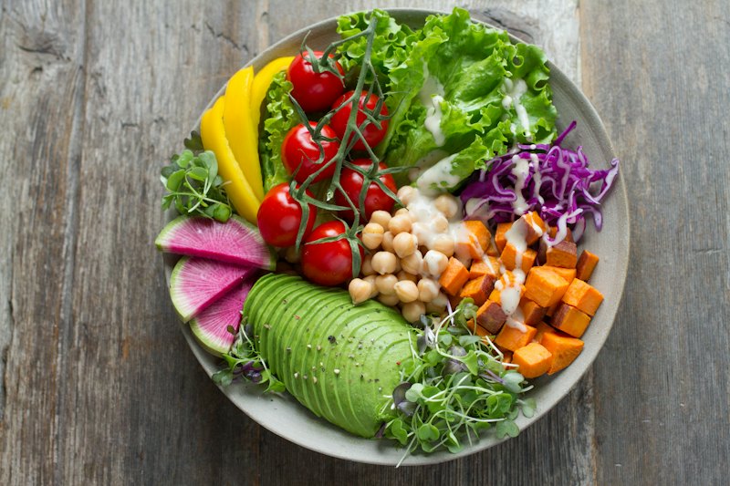 Fresh salad with greens, tomato and avocado