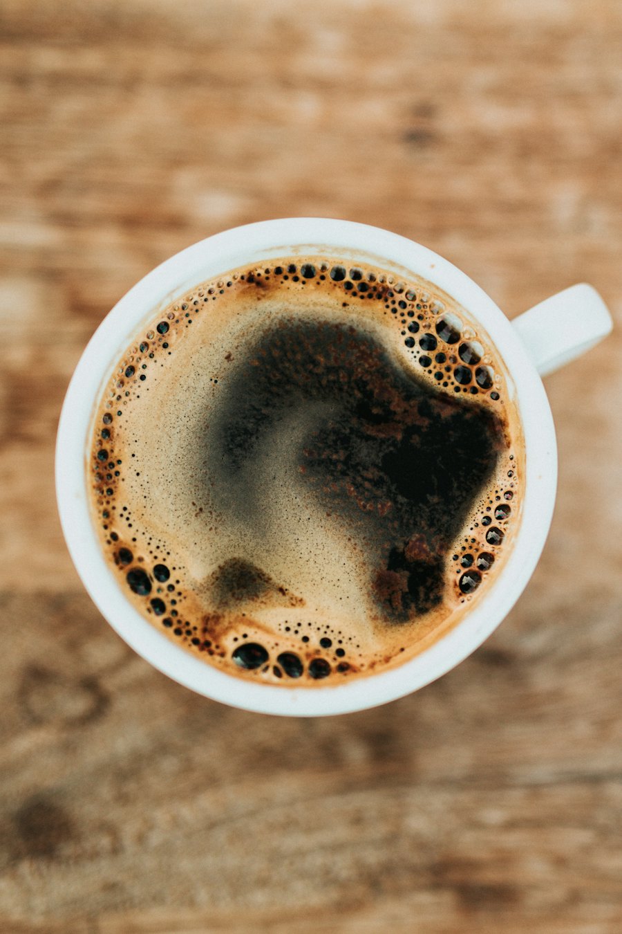 Overhead view of a freshly poured cup of black coffee