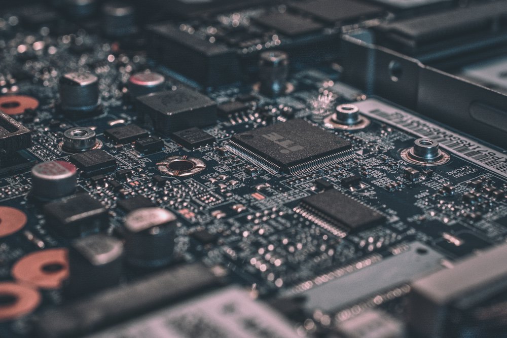 Close-up of a green printed circuit board with chips
