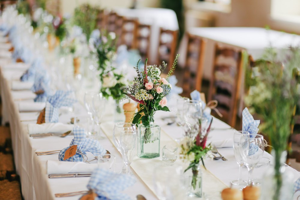 Wedding reception table with wildflower centrepieces