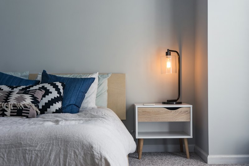 Bright bedroom with linen bedding and wooden floor