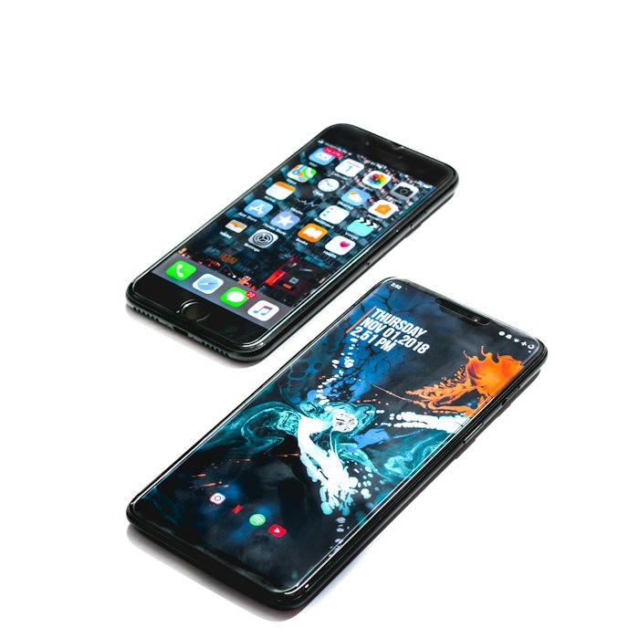 A black smartphone on a dark surface