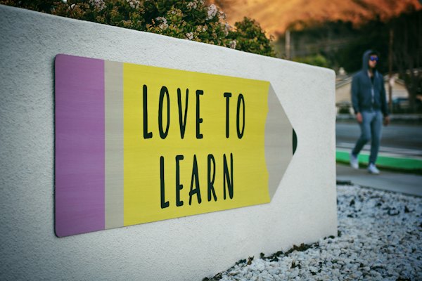 Pencil-shaped sign reading Love to Learn