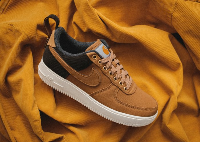 Tan sneaker resting on mustard fabric