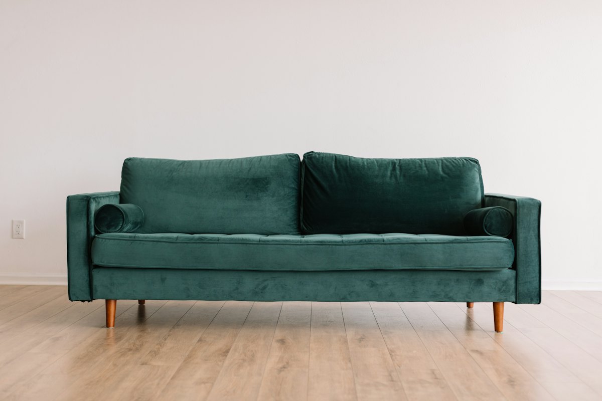 Linen sofa in a bright living room with oak side table