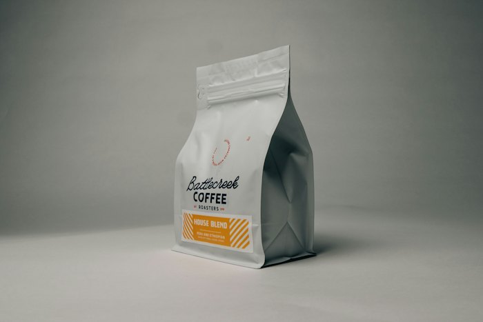Retail bag of whole-bean coffee on a grey background