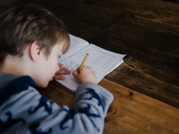 Child reading at a wooden table