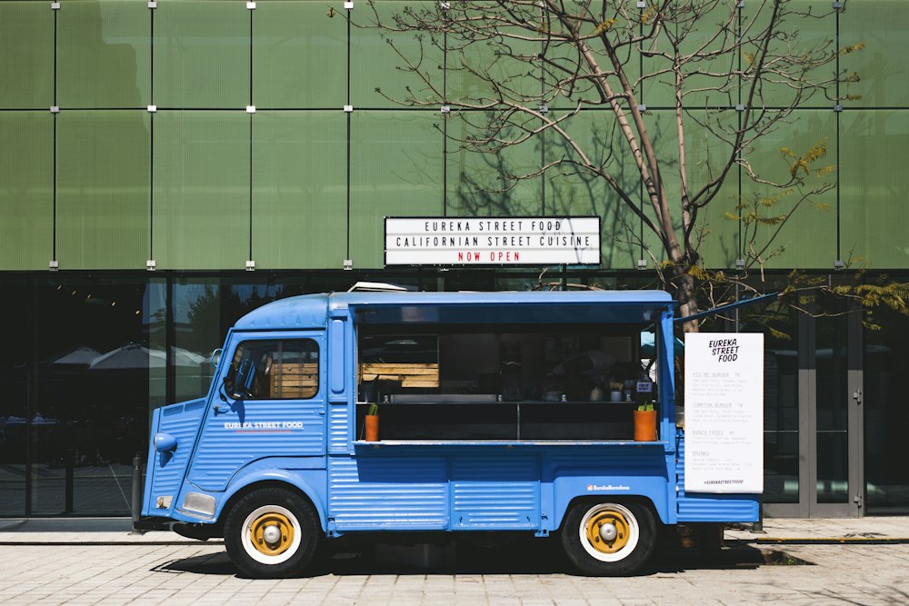 Brightly painted food truck serving customers at dusk