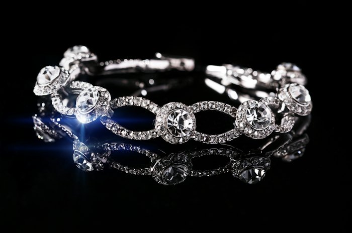 Diamond-set band resting on black glass