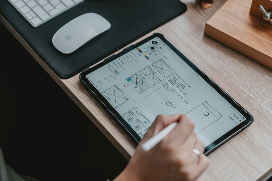 A designer sketching interfaces on a tablet
