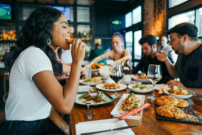 Guests sharing dinner at a restaurant table