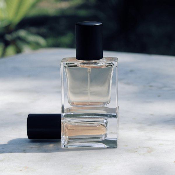 Clear glass mist bottle with a black cap