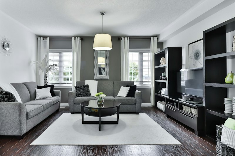 Tidy living room with a grey sofa and shelves