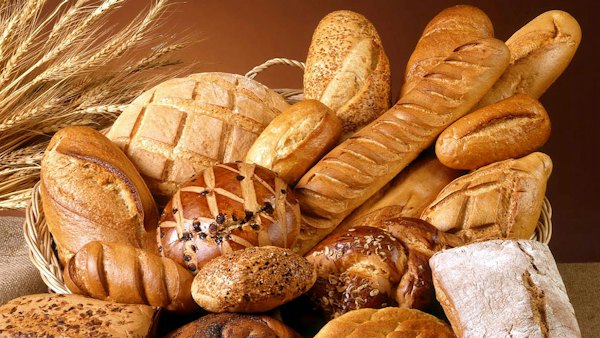 Assorted fresh loaves and rolls piled in a basket