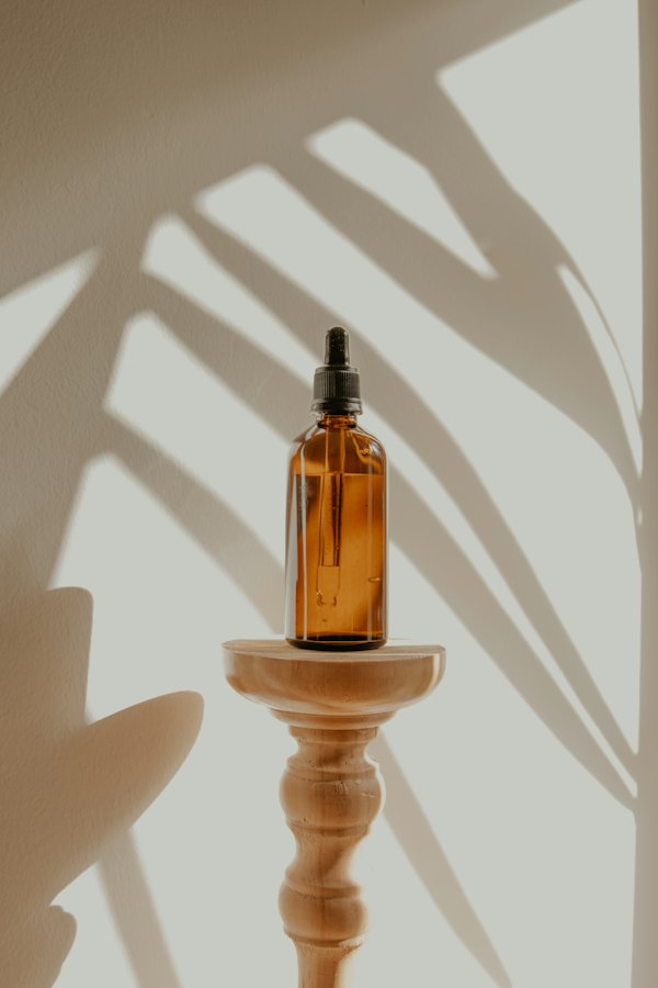 Amber dropper bottle on a wooden stand