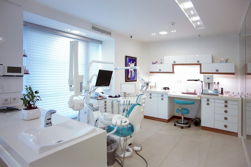 Modern dental treatment room with a reclining chair