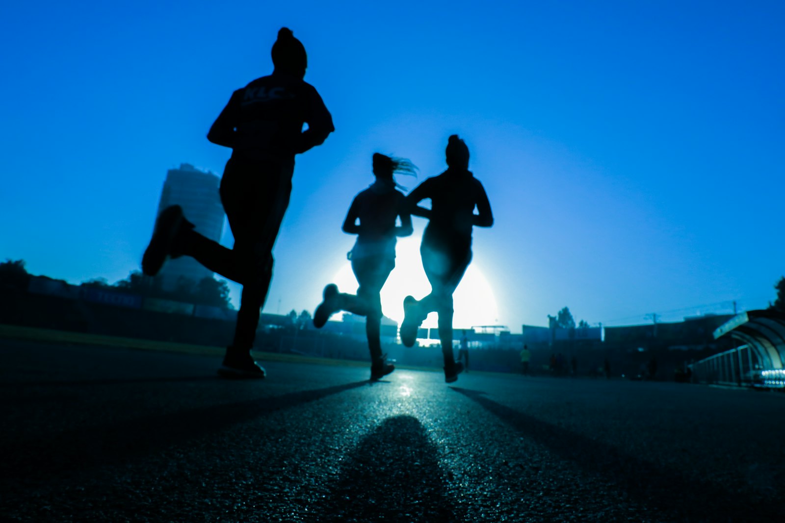 Runners sharing the road at sunset